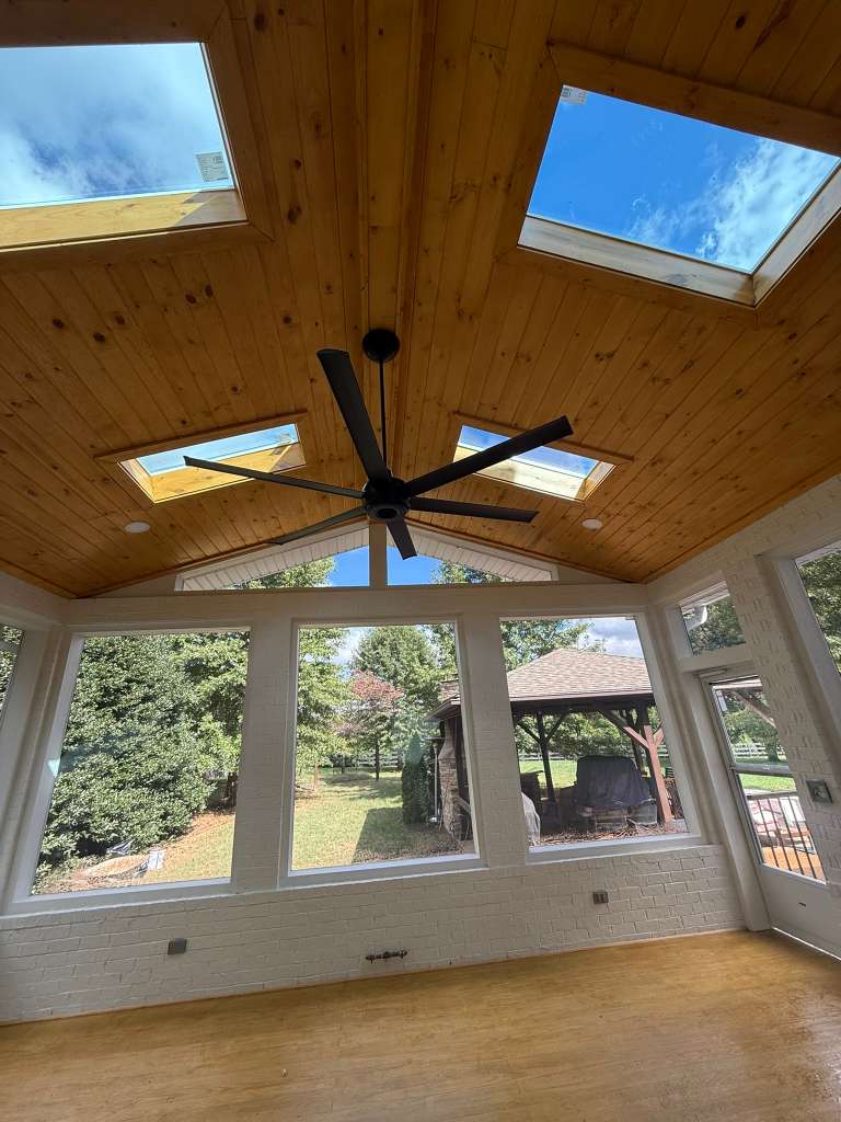 Sunroom porch interior with skylights and ceiling fan